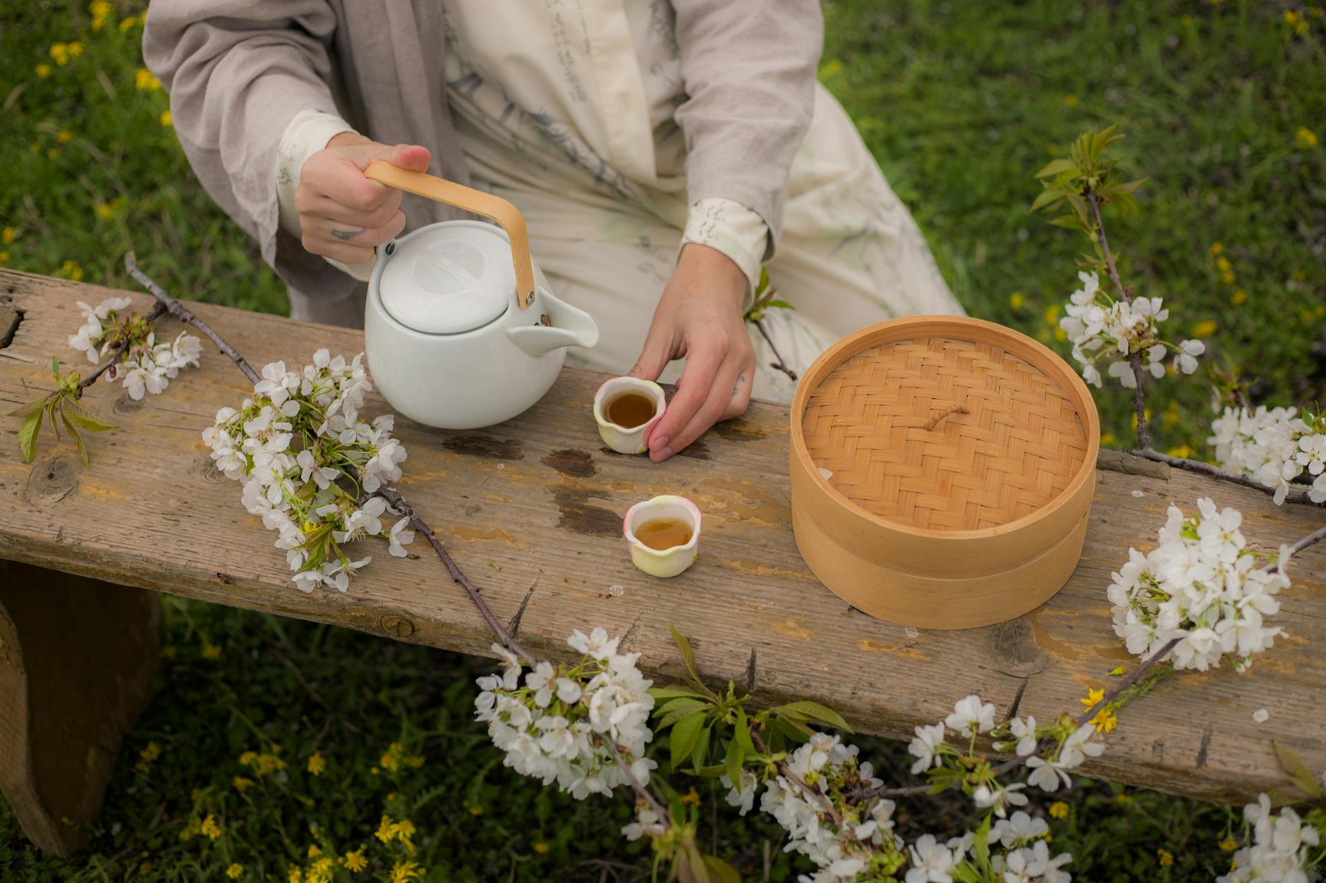 Enjoy a serene tea ceremony surrounded by blooming cherry blossoms in spring. - spring wellness rituals