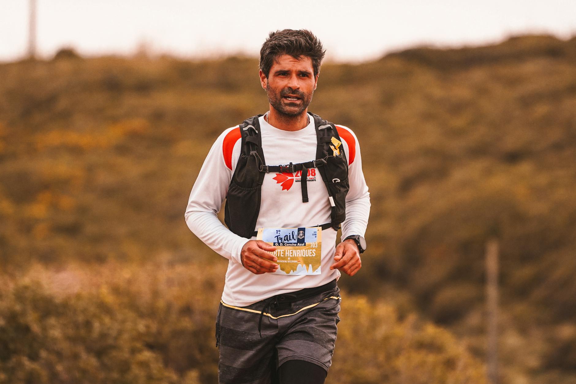 Trail runner with determination competing in an outdoor marathon event. - trail running beginners