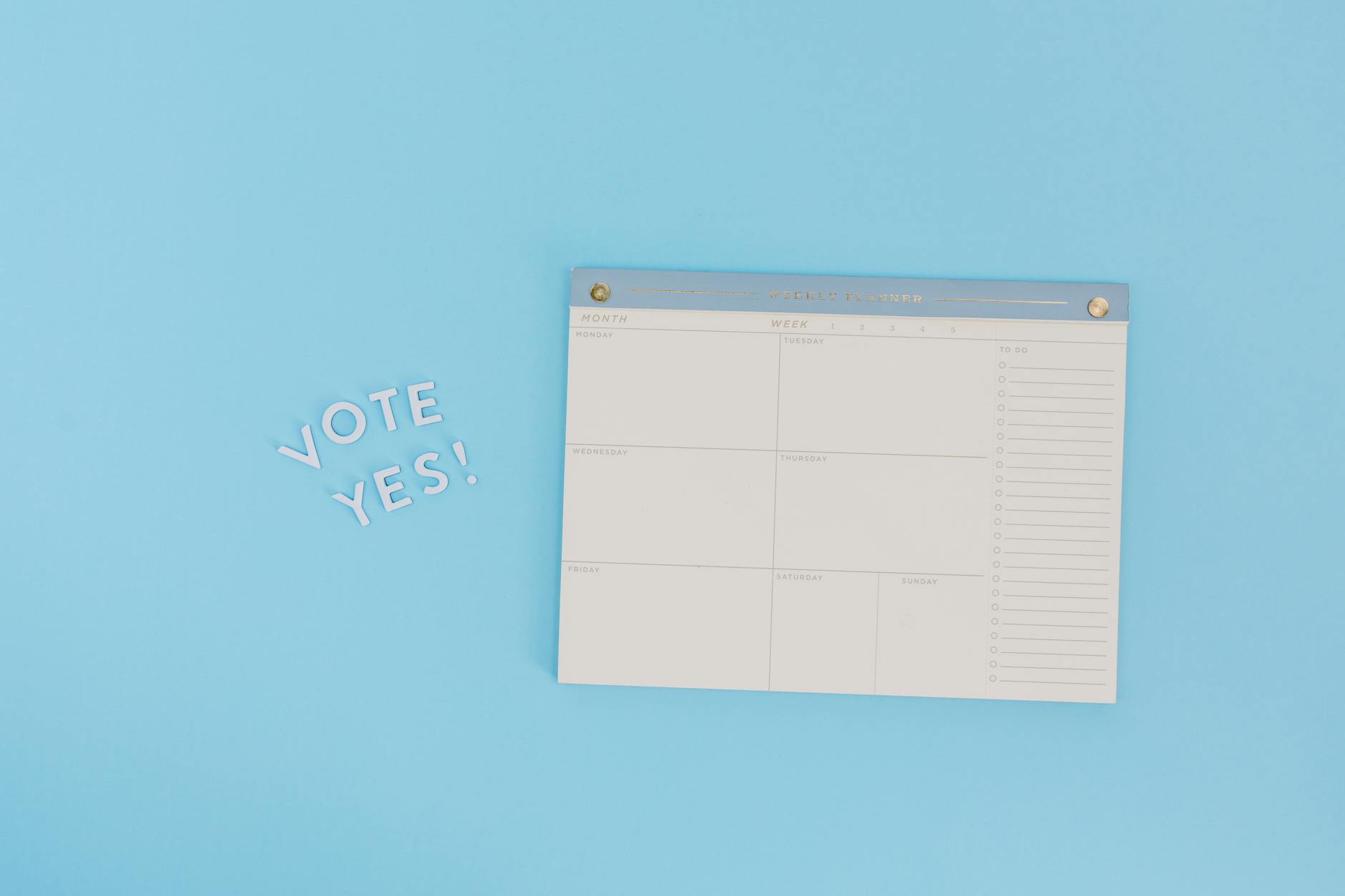 Minimalist image of a planner and "Vote Yes" text on a blue background, perfect for election themes. - weekly workout plan