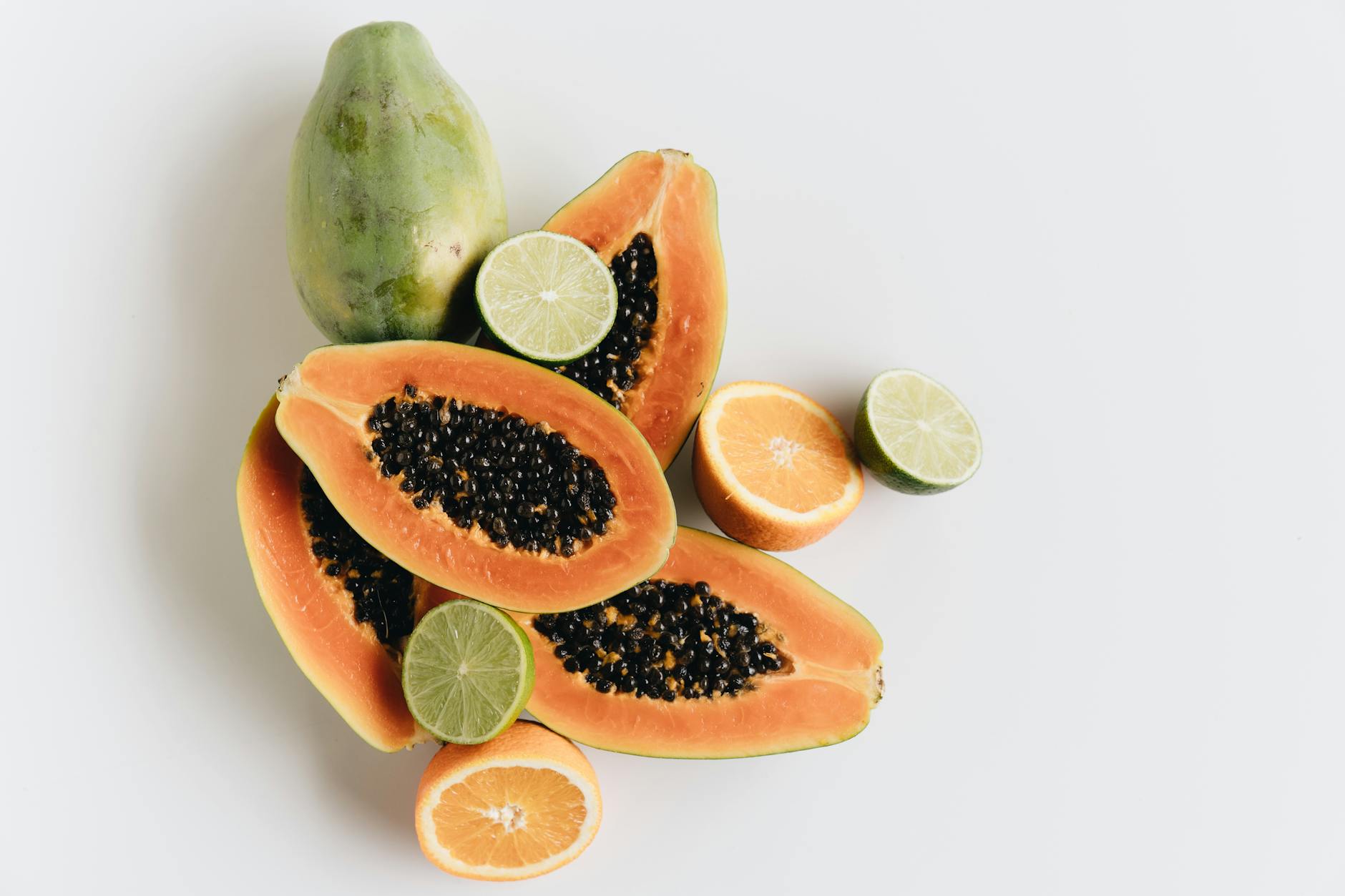 Top view of vibrant papaya, lime, and orange slices showcasing freshness - boost immune system naturally