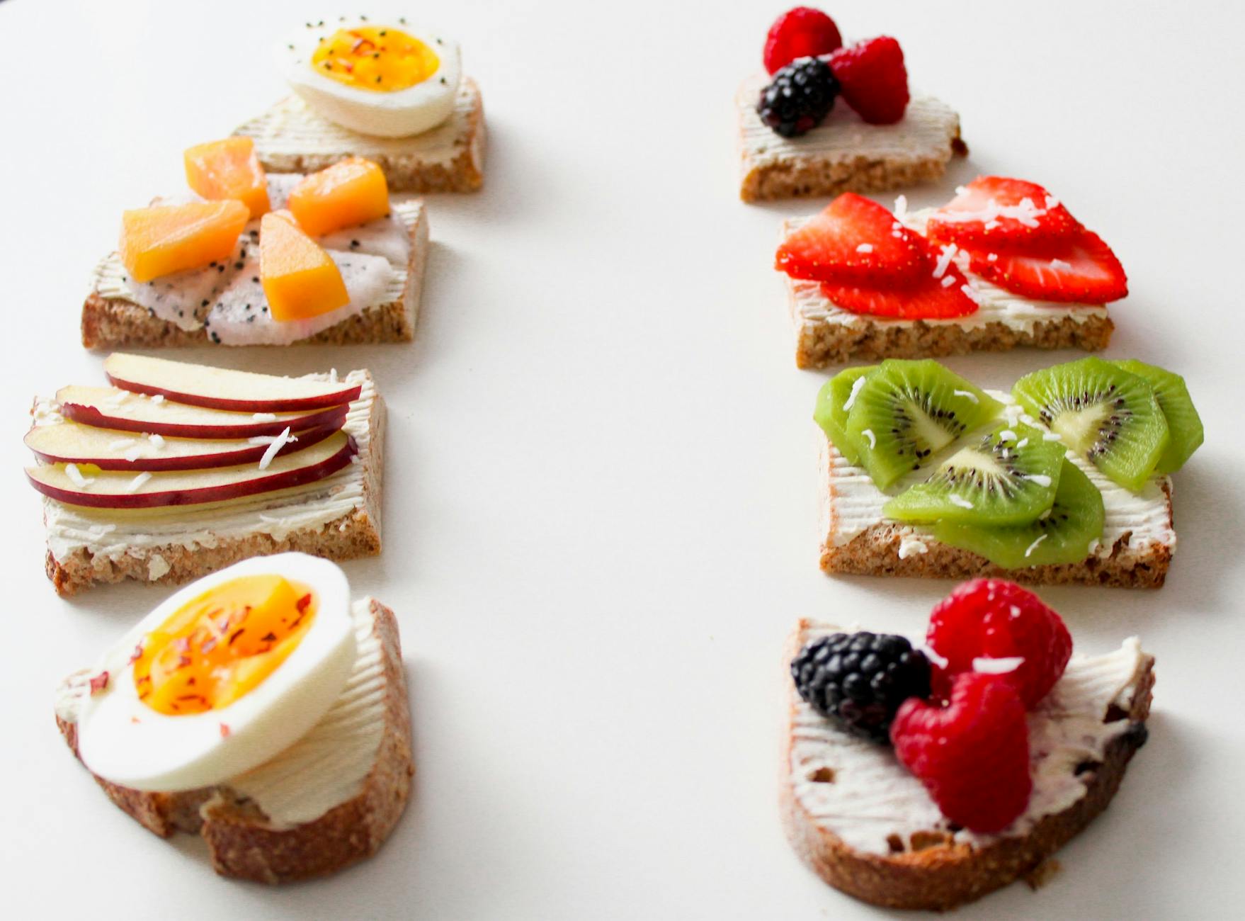 Delicious selection of open-faced fruit and egg sandwiches on whole grain bread for a healthy breakfast. - healthy snack recipes