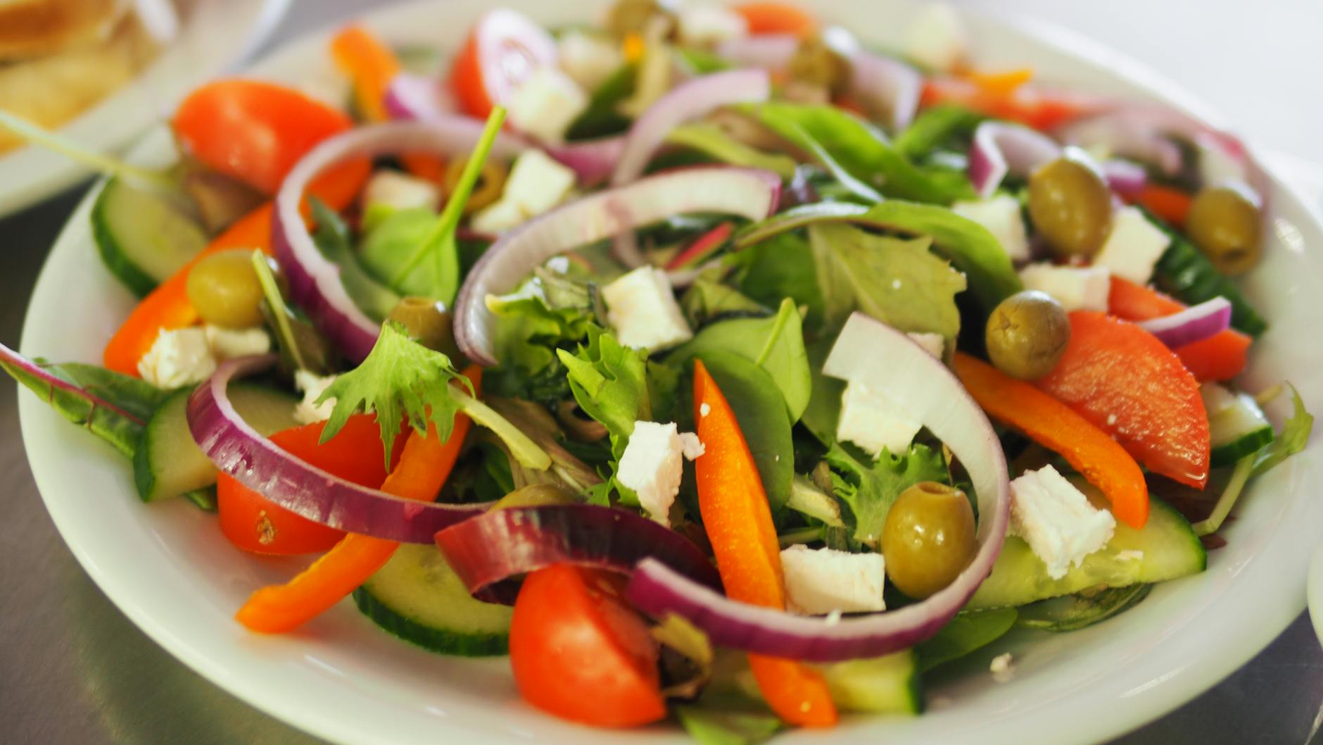 A vibrant Mediterranean salad featuring fresh vegetables, olives, and feta cheese for a healthy meal. - healthy spring salads