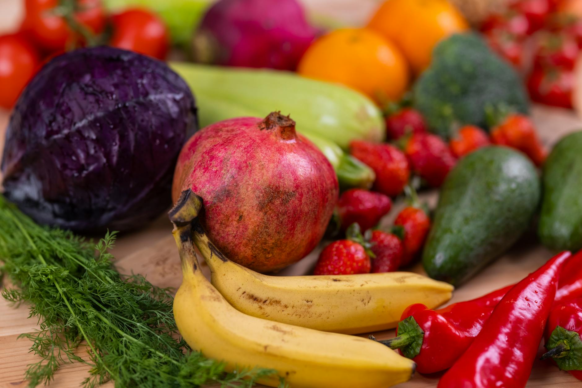 A variety of fresh fruits and vegetables arranged beautifully on a wooden table, showcasing natural nutrition. - raw food nutrition
