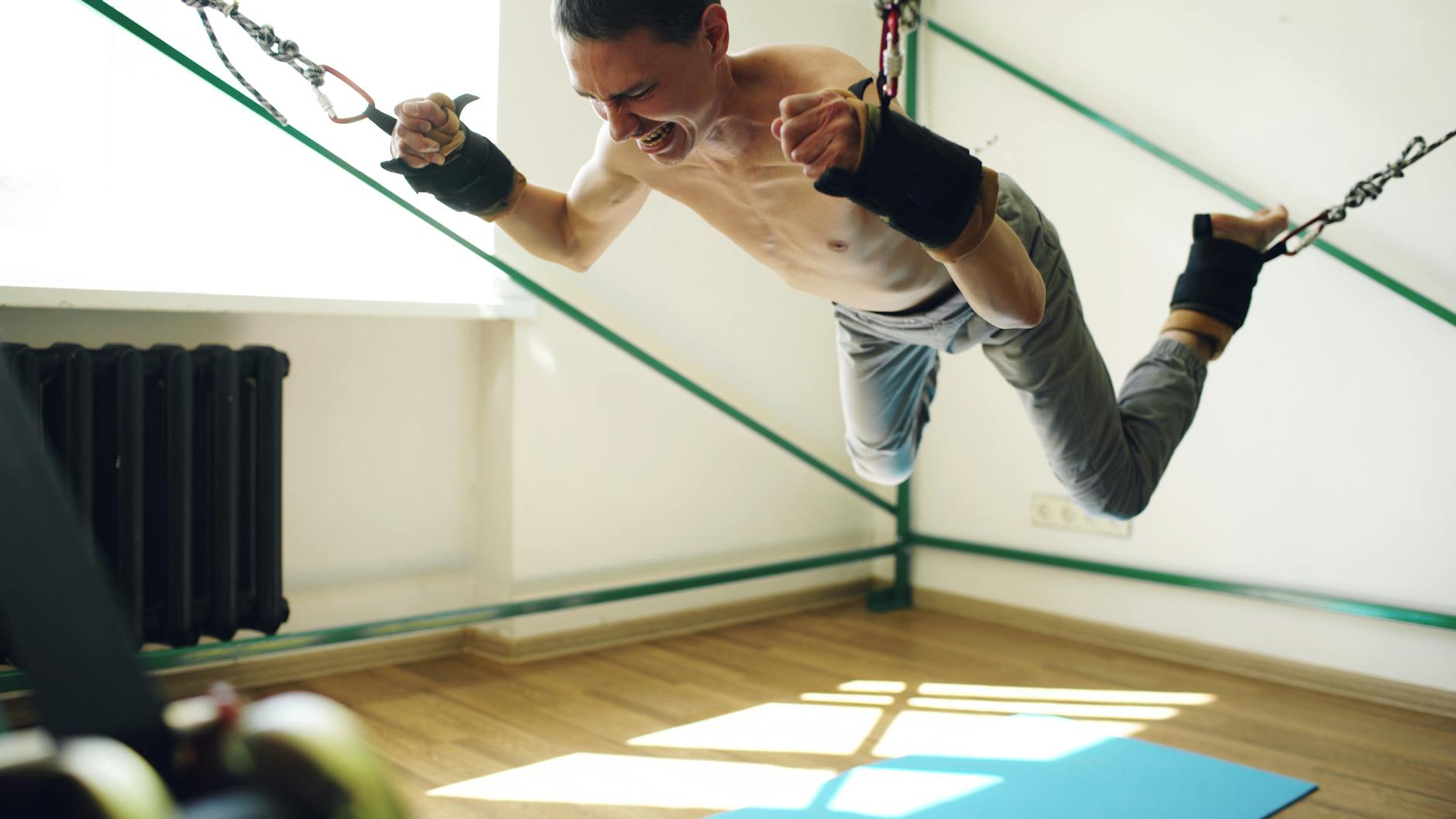Man in intense resistance training exercise indoors, showing dedication and strength. - resistance training benefits