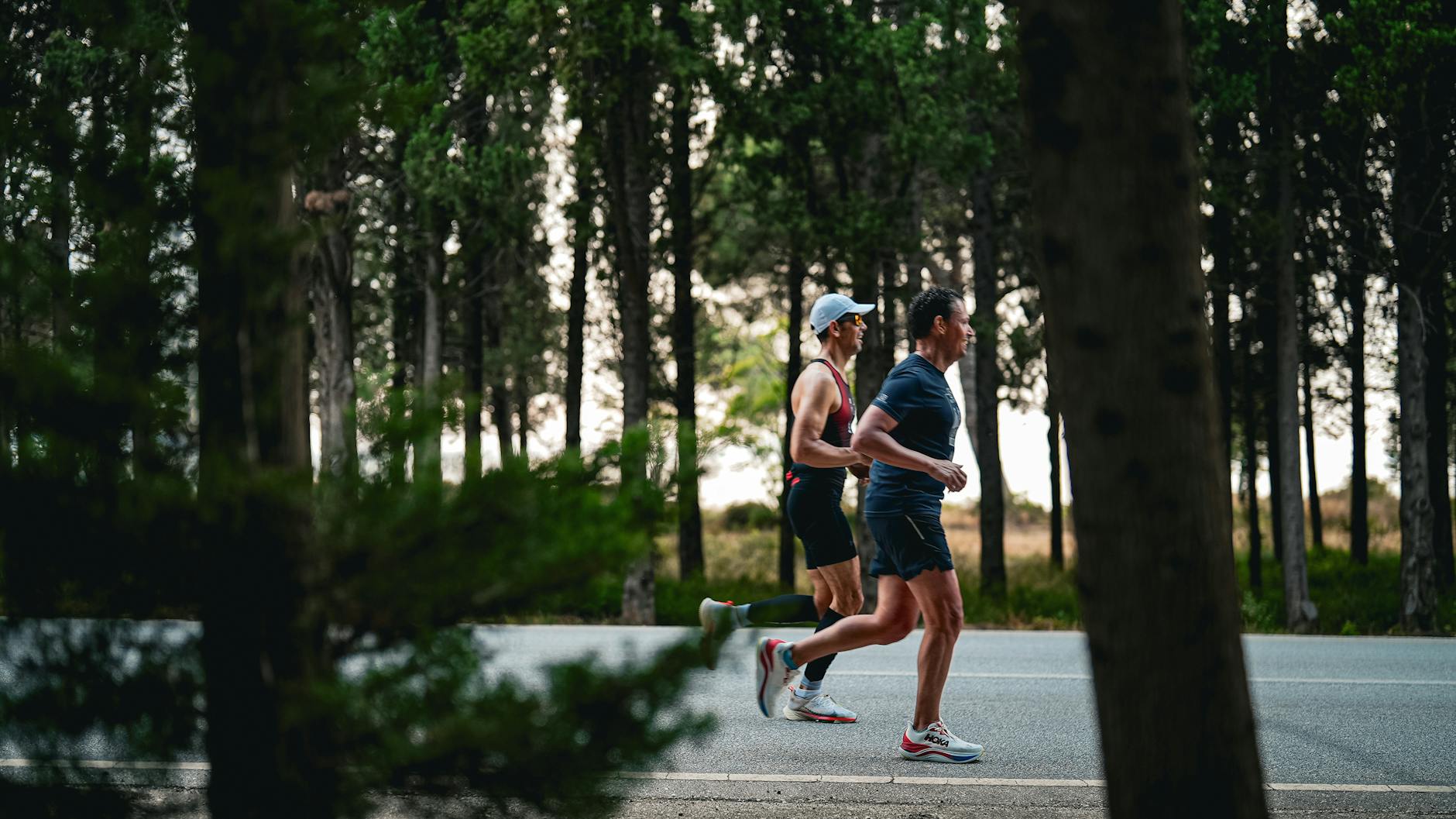Two adults jogging on a forest road in Gelibolu, Türkiye. - running plan for beginners