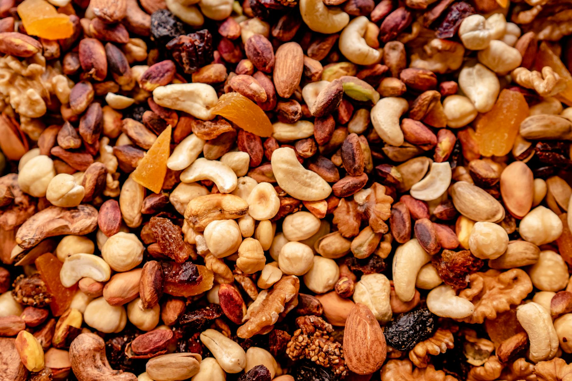 Close-up of assorted nuts and dried fruits creating a colorful, nutritious mix. - spring energy foods