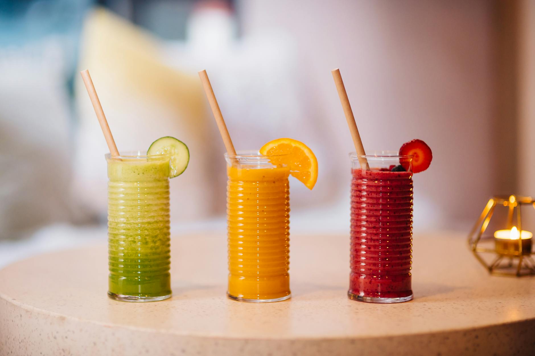 Three vibrant fruit smoothies with bamboo straws, perfect for a refreshing summer drink. - green smoothie benefits