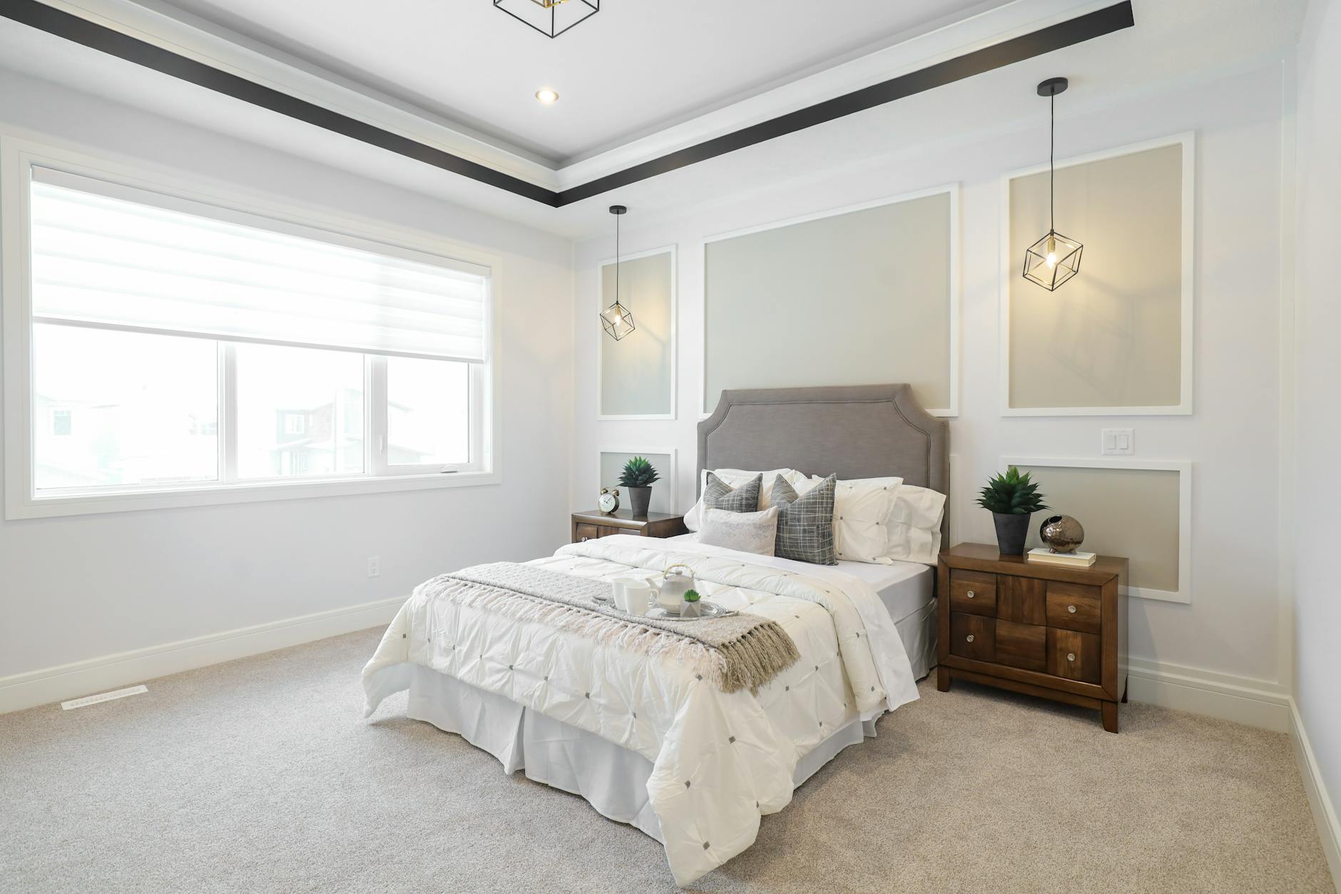 A contemporary bedroom in Edmonton, featuring stylish lighting and minimalist decor. - restful bedroom environment