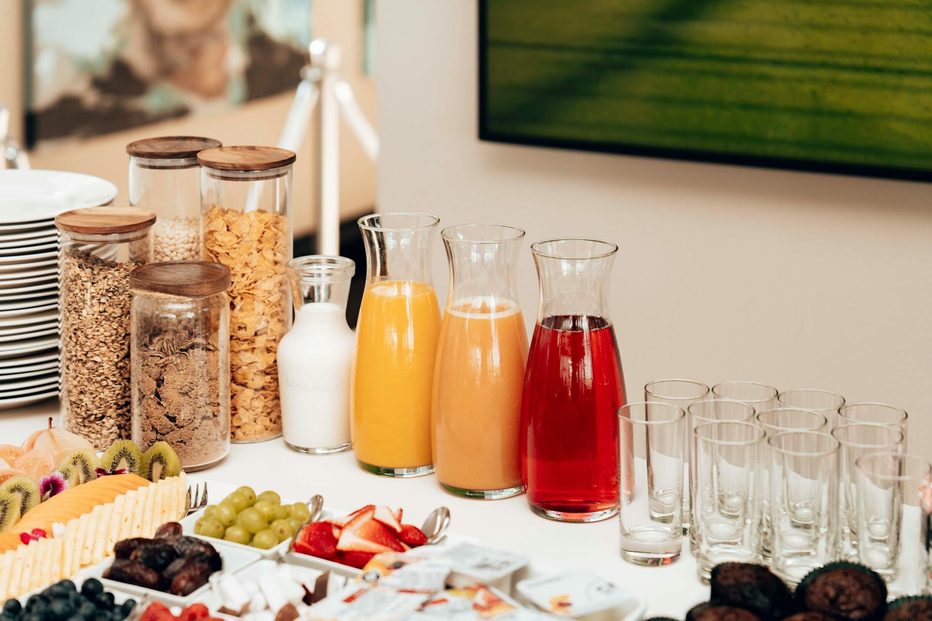 An inviting breakfast buffet featuring juices, cereals, milk, fruits, and cutlery. - spring energy breakfast