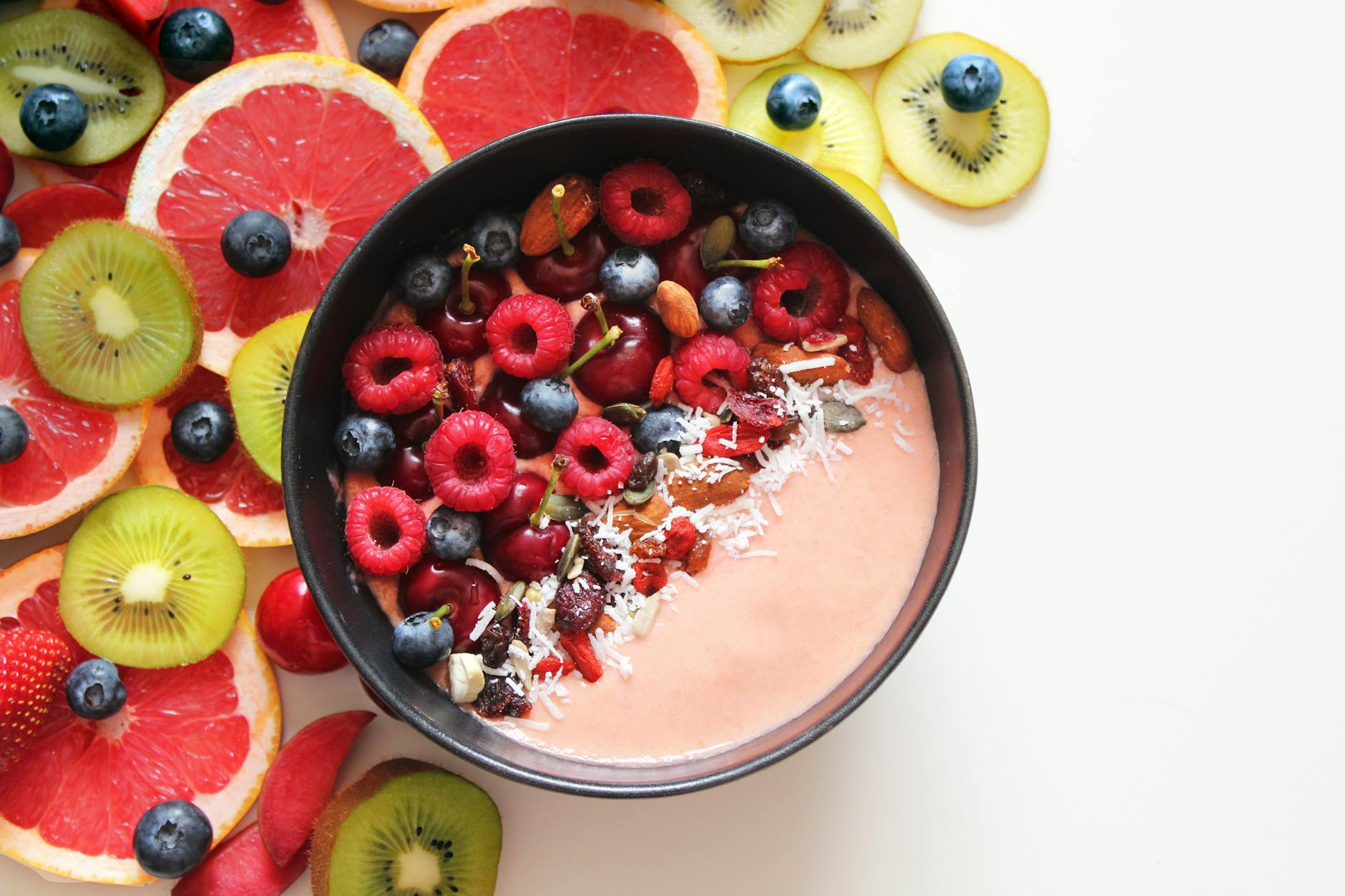 Colorful smoothie bowl with berries and tropical fruits, perfect for a healthy breakfast. - spring fruits energy